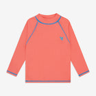 A red, long-sleeved UV Protective Rash Vest, with a blue logo and trim around the neck, wrists and hem, and blue stitching on the seams.